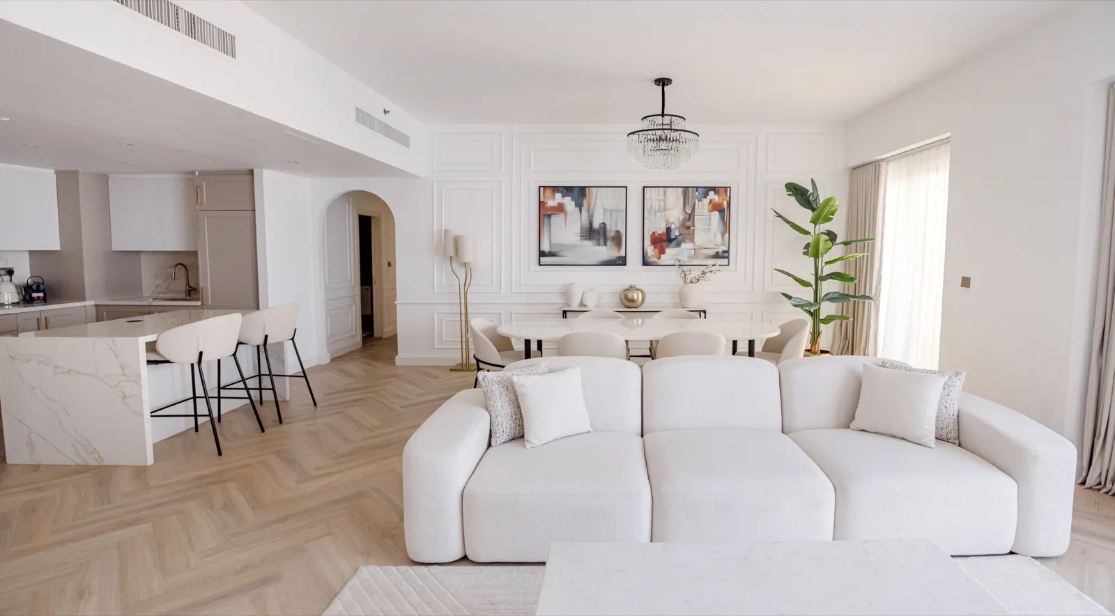 Bright living room with cream sofas and herringbone floors